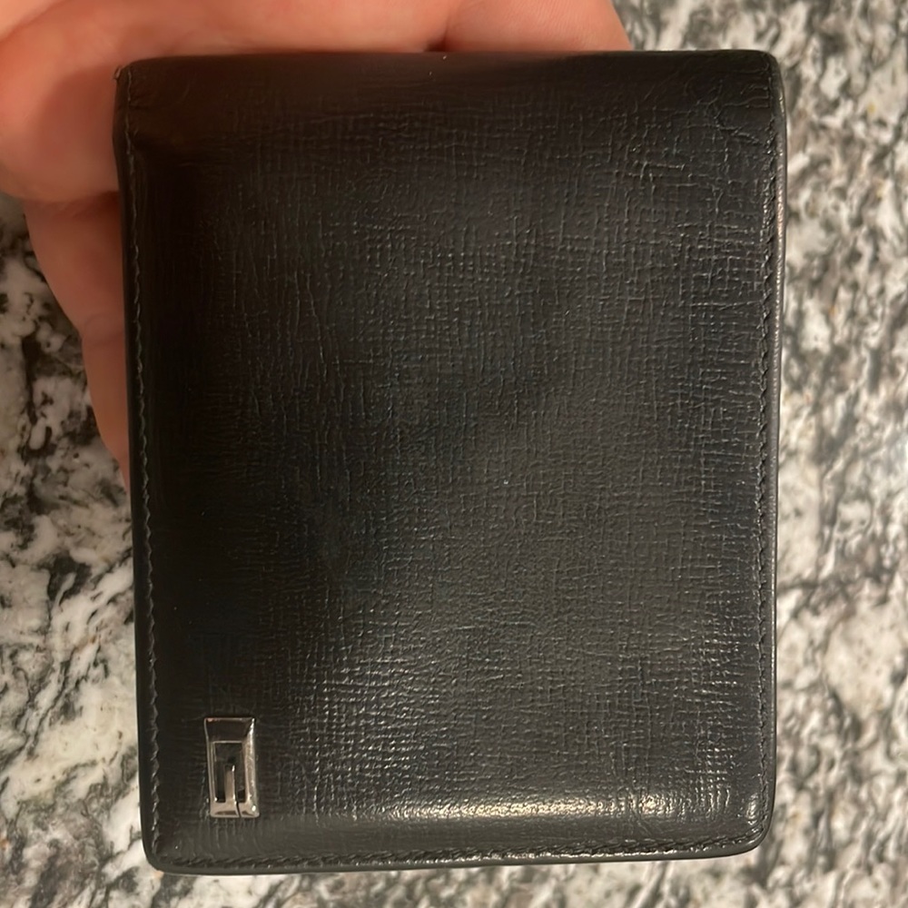 Used Gucci wallet Black w. Silver G Logo.  Still in great condition.